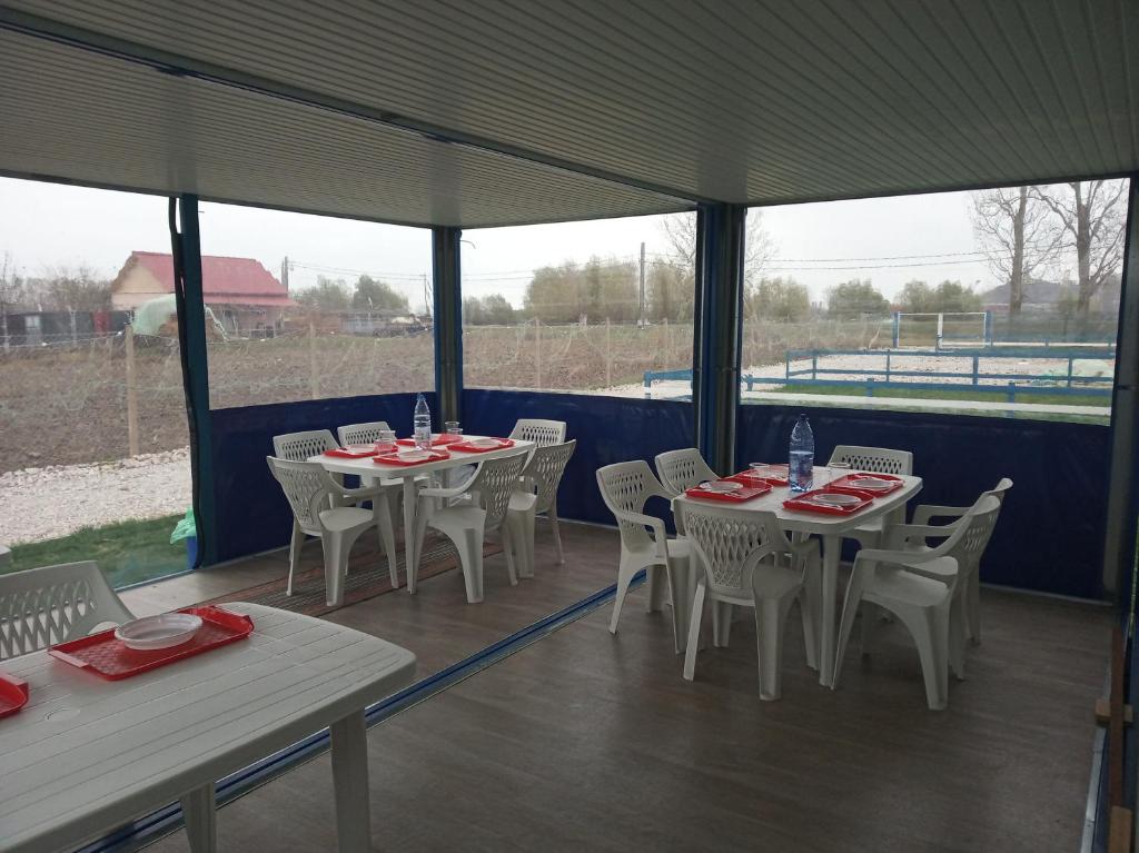 a row of tables and chairs under a tent at Camping Danubius Tulcea in Tulcea