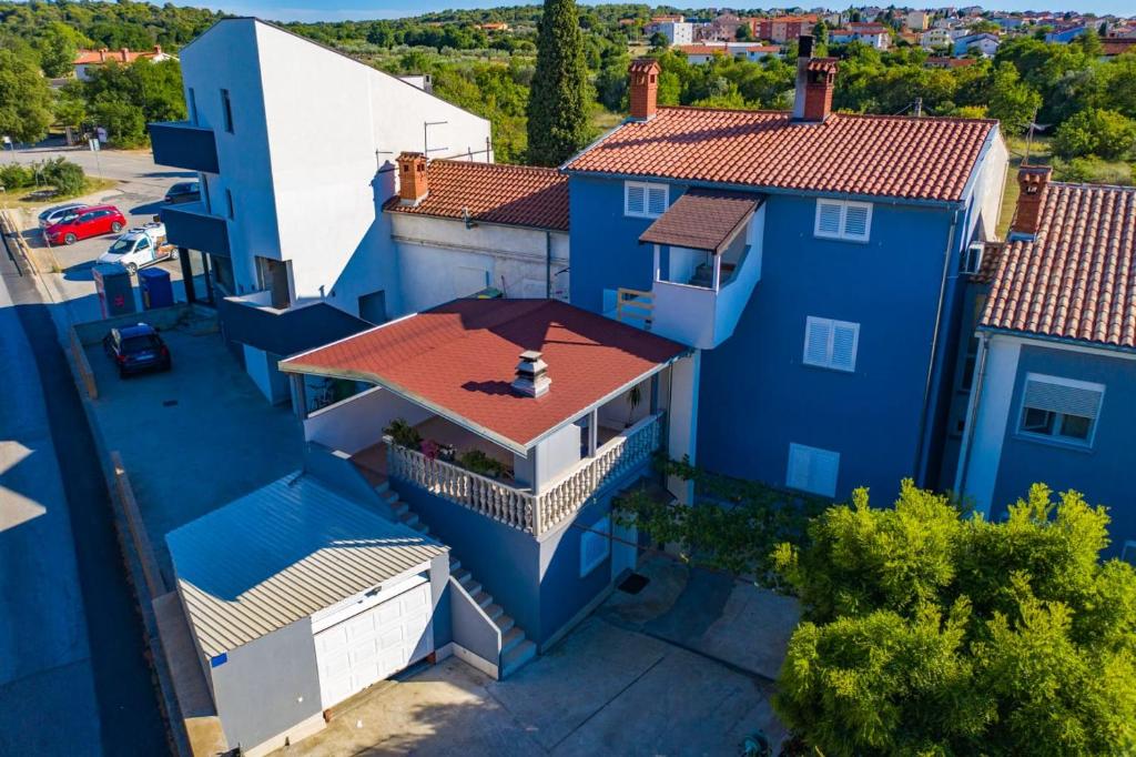an overhead view of a blue house with a red roof at Apartman Ana in Štinjan