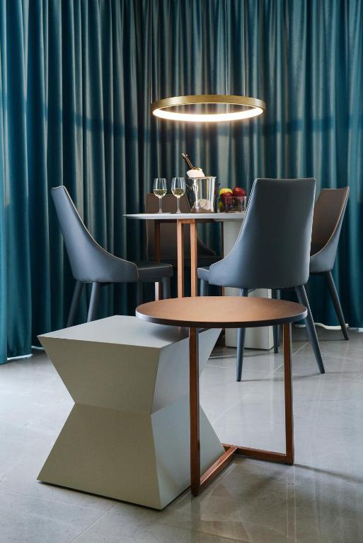 a table and chairs in a room with a table and two chairs at L-Suites in Kavála