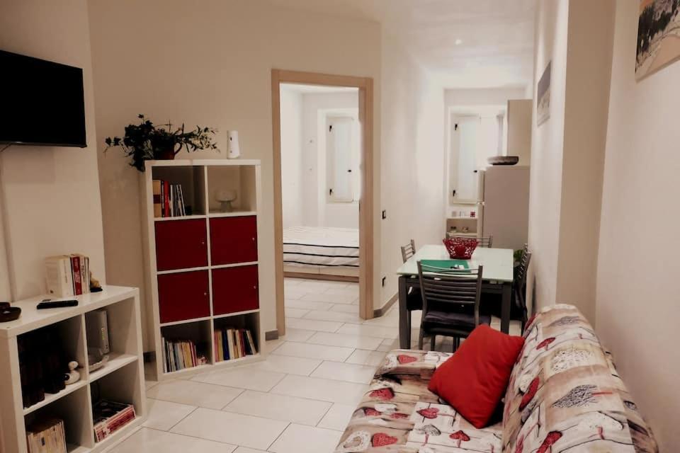 a living room with a couch and a dining room at Apt Is Fradis in Cagliari