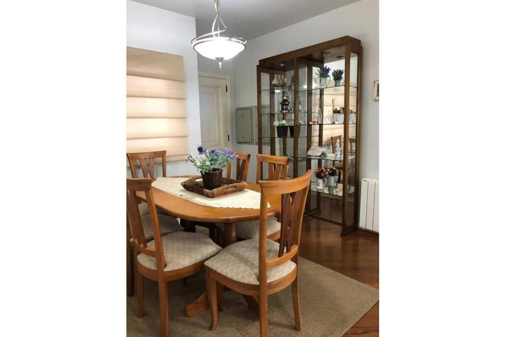 a dining room with a table and chairs at MRG - Ensolarado 2D - Centro de Gramado in Gramado