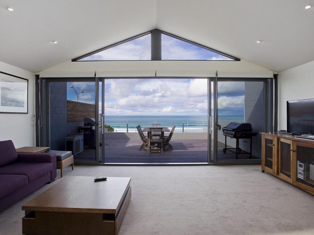 a living room with a view of the ocean at One 36 in Lorne