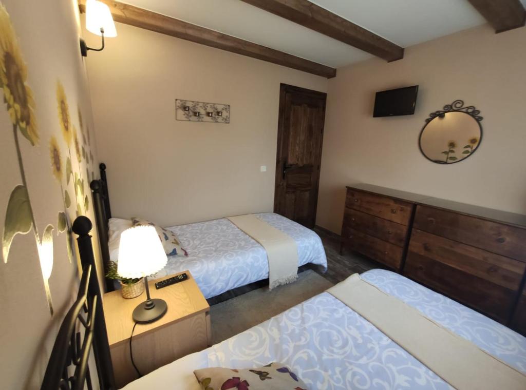 A bed or beds in a room at LAS 4 ESTACIONES - Rascafría