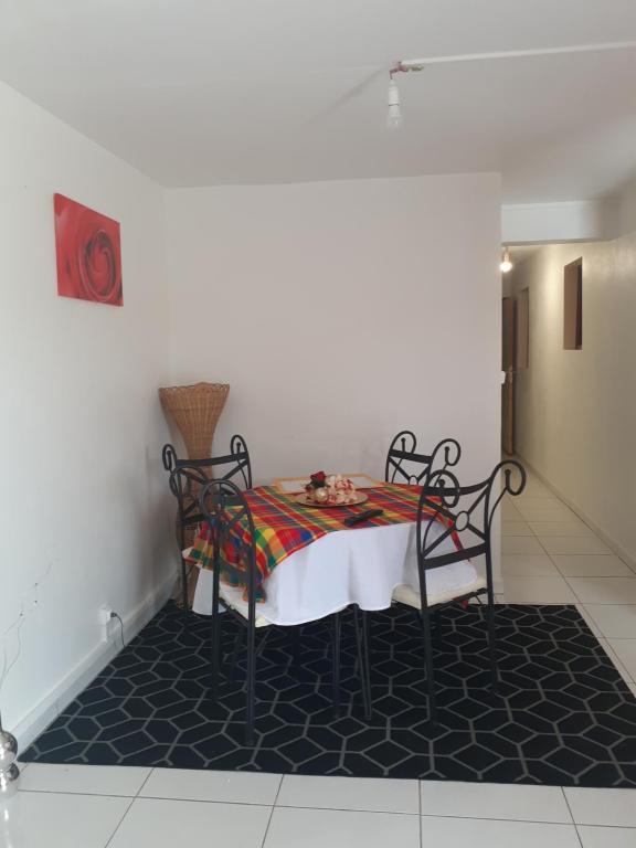 a dining room table with a white table cloth on it at Divima in Sainte-Anne