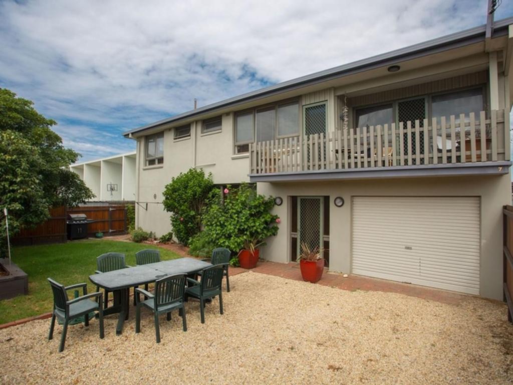 a table and chairs in front of a house at Banksia Seven in Merimbula