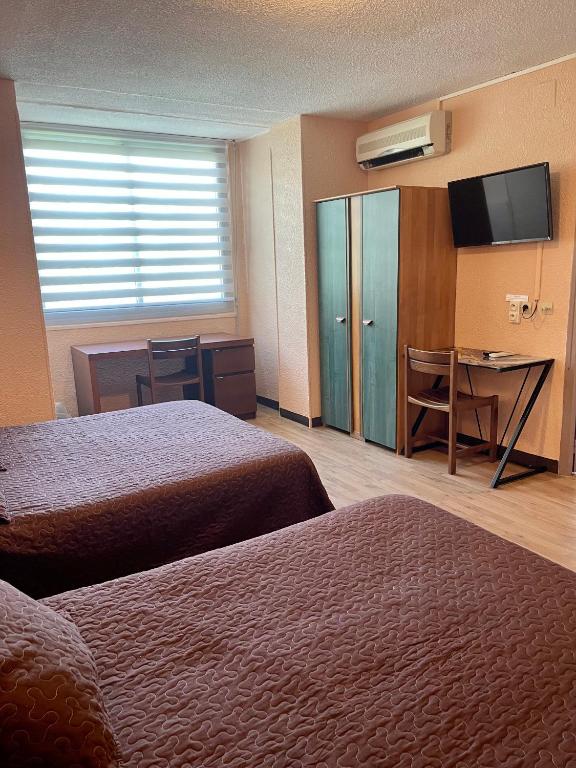Postel nebo postele na pokoji v ubytování Hotel Alexander