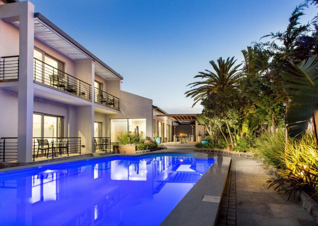 a swimming pool in front of a house at Ocean Bay Guesthouse in Port Elizabeth