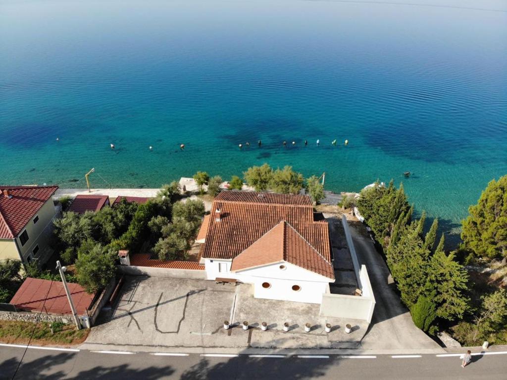 an aerial view of a house next to the ocean at Apartman Dubravko Tribanj in Starigrad