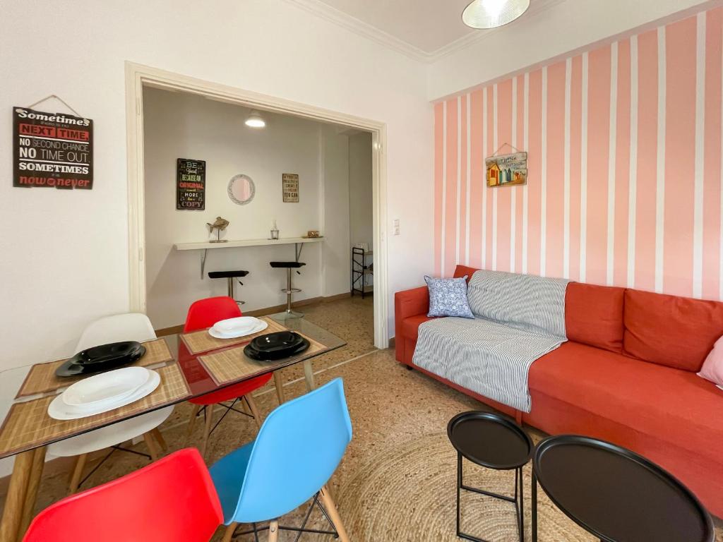 a living room with a couch and a table and chairs at SOHO Vibrant 55sqm apt in Athens in Athens