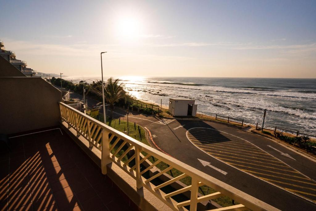 a view of the ocean from the balcony of a building at Ocean blues Isikhulu 7 in Umdloti