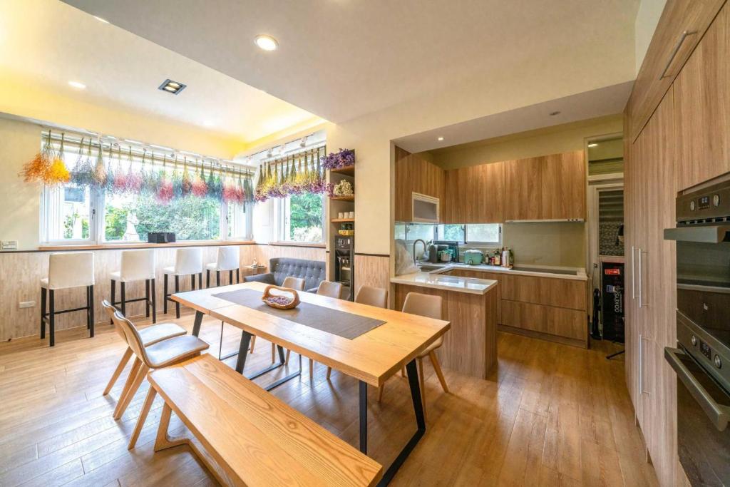 a large kitchen with a wooden table and chairs at Caspia in Wujie