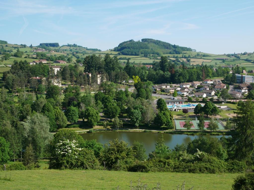 a view of a town and a lake in a field at Camping de Matour in Matour