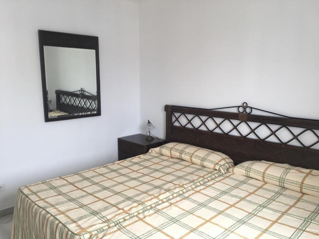 Posteľ alebo postele v izbe v ubytovaní Apartamentos El Minarete