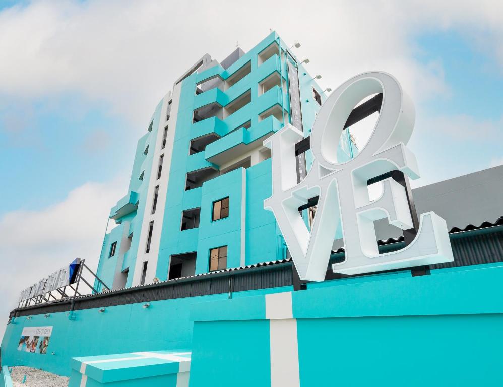 a building with a large white qr sign on it at Hotel LOVE JEWEL in Kitakyushu