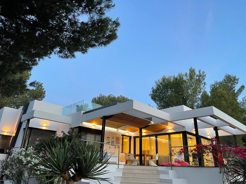 a large white house with a lot of windows at Nyumba ya Sun in Cala Tarida
