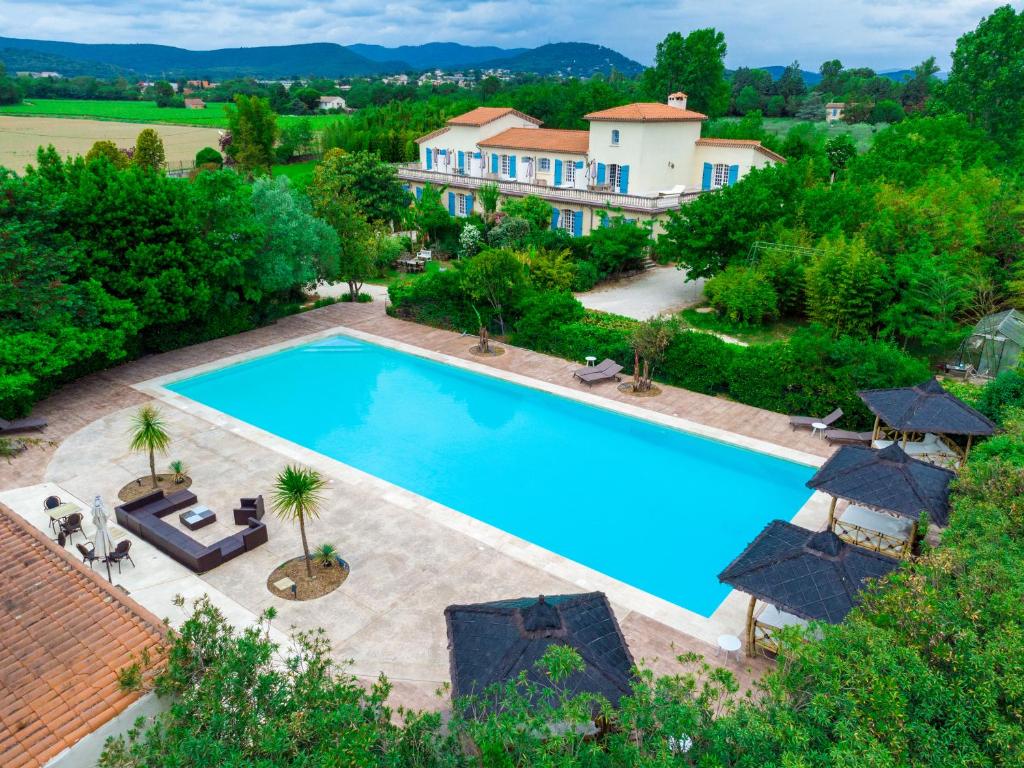 an aerial view of a swimming pool in front of a house at La Demeure de l'Arche in Saint-Christol-lès-Alès