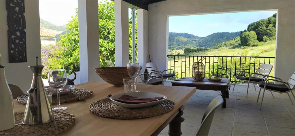 a dining room with a table with a view at Finca Las Morenas in Yunquera