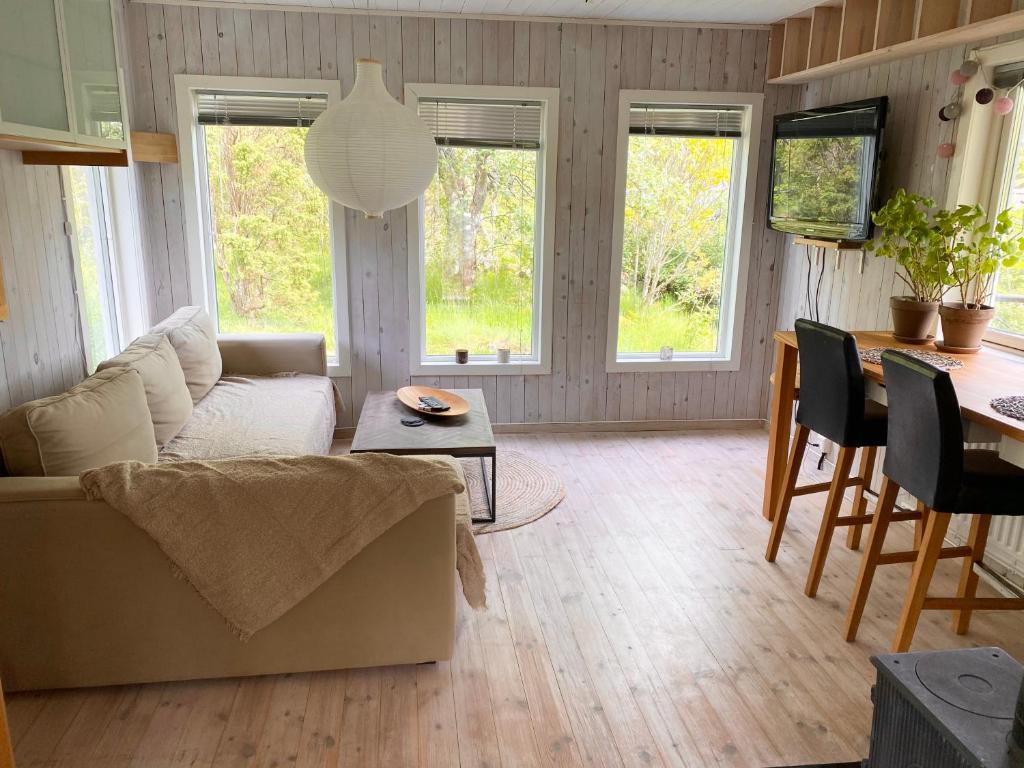 uma sala de estar com um sofá e uma mesa em Stuga på Rossö, Strömstad em Strömstad