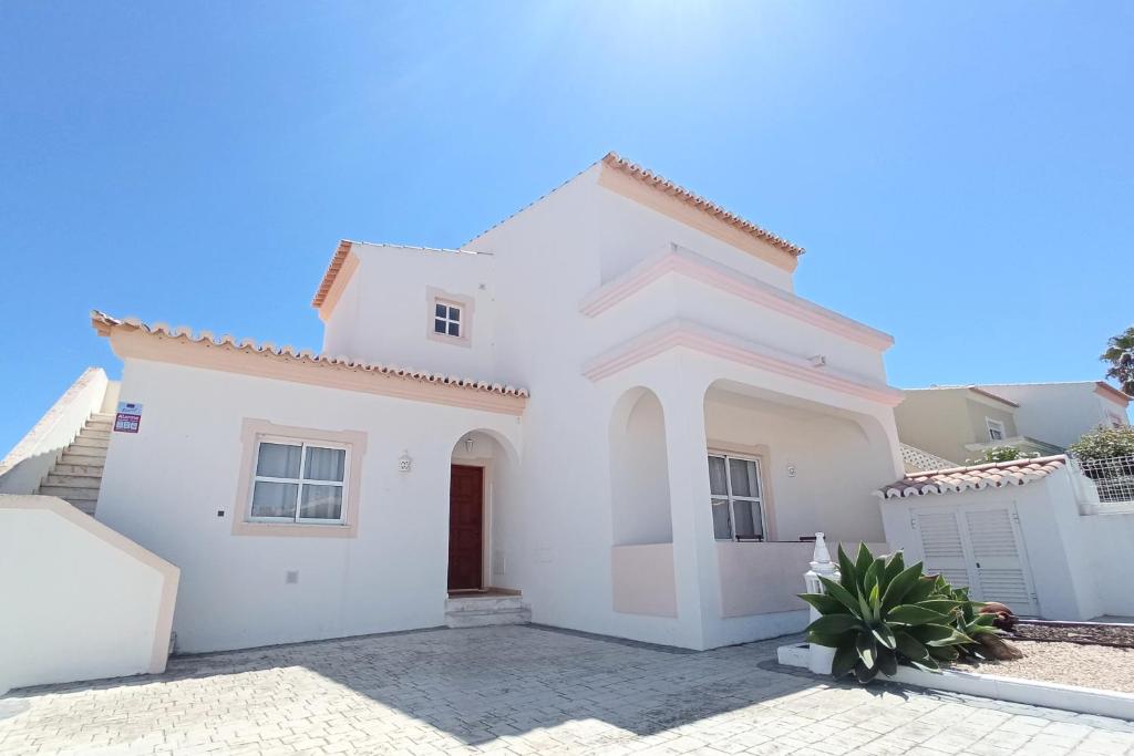 a white house with a gate and a driveway at Villa Alvor 7 by amcf in Alvor