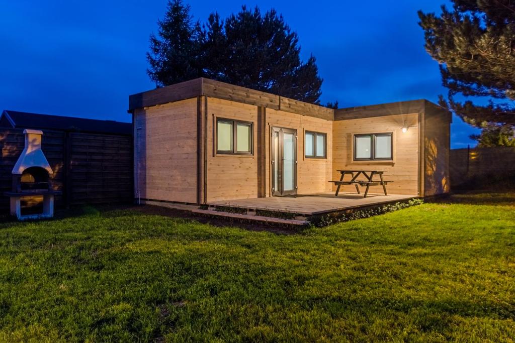 a tiny house on a lawn at night at Domki u Moni in Karwieńskie Błoto Pierwsze