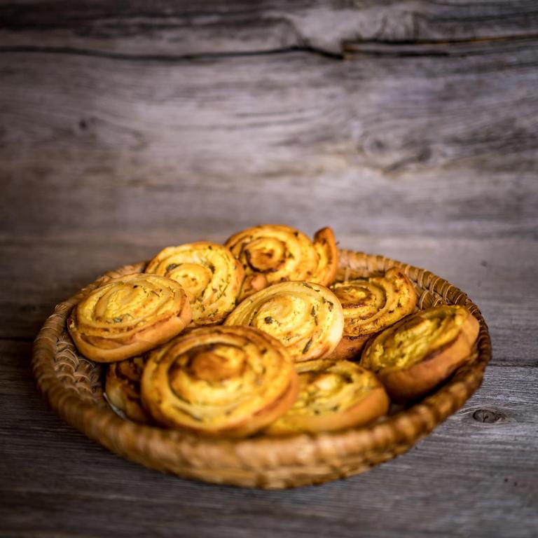 a basket filled with baked food on a wooden table at Tourist Farm Šenkova Domačija in Zgornje Jezersko