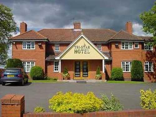 a large brick house with ansics house sign on it at Tri-Star Hotel in Birmingham