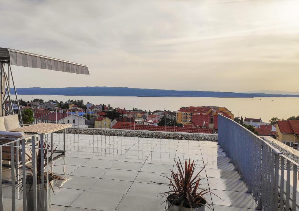 a balcony with a view of a city and water at Drance 16 Apartments in Selce