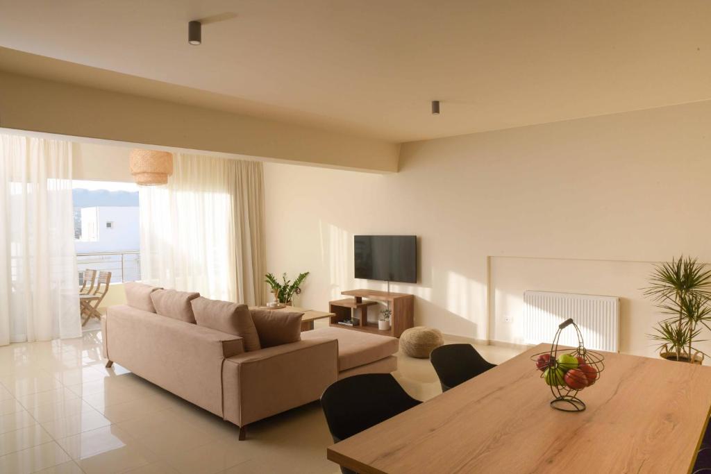 a living room with a couch and a table at Oikies Luxury Apartments with private free parking area in Agios Nikolaos