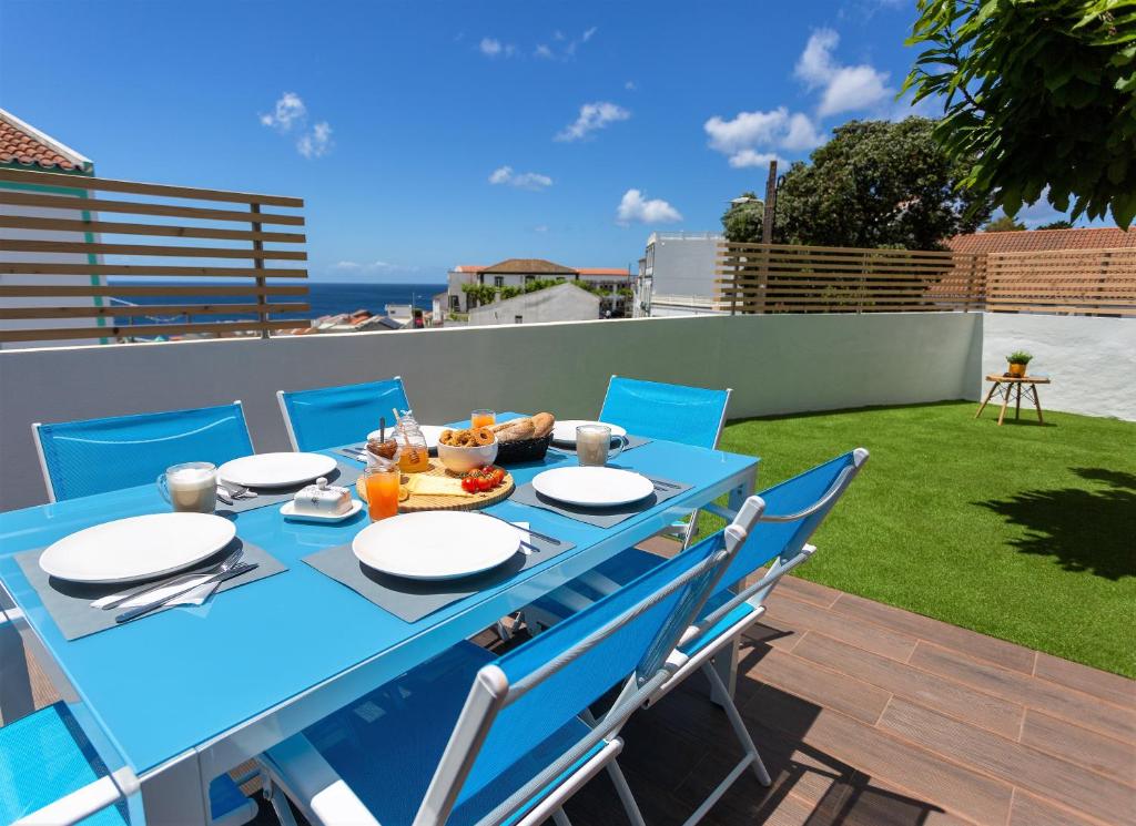 a blue table and chairs on a patio at Castanheiro in Lagoa