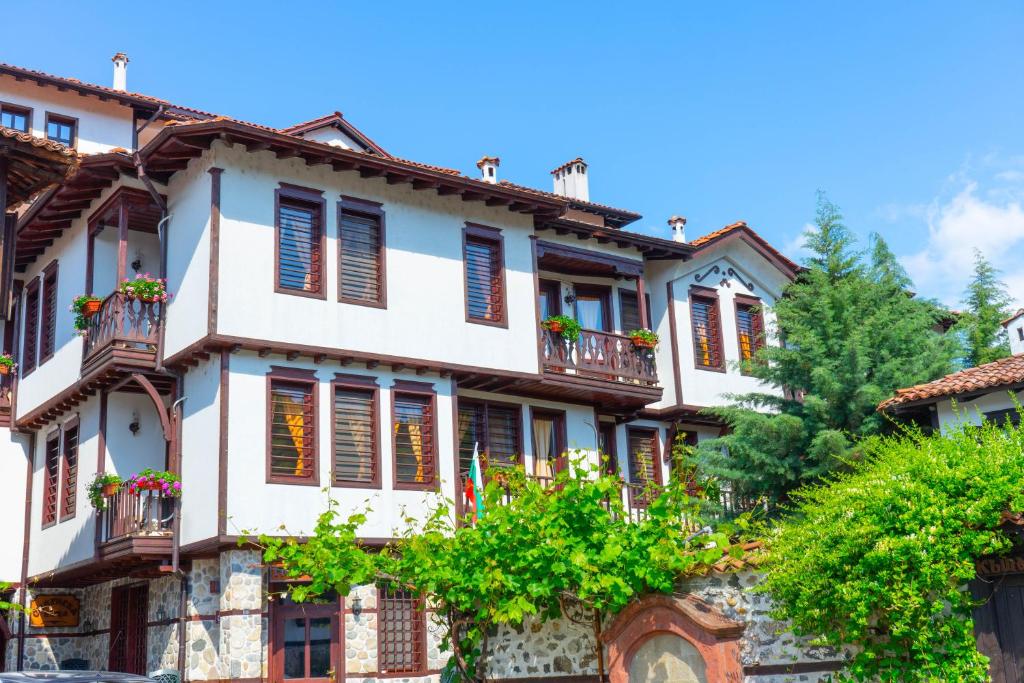 an old house with balconies and trees at Sivrieva House in Zlatograd