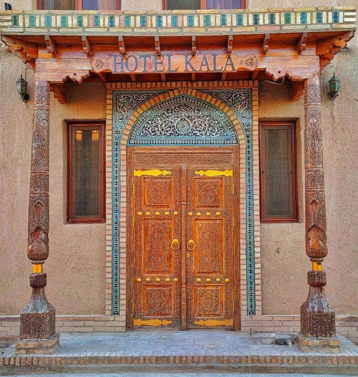 an entrance to a building with a wooden door at KALA Khiva in Khiva