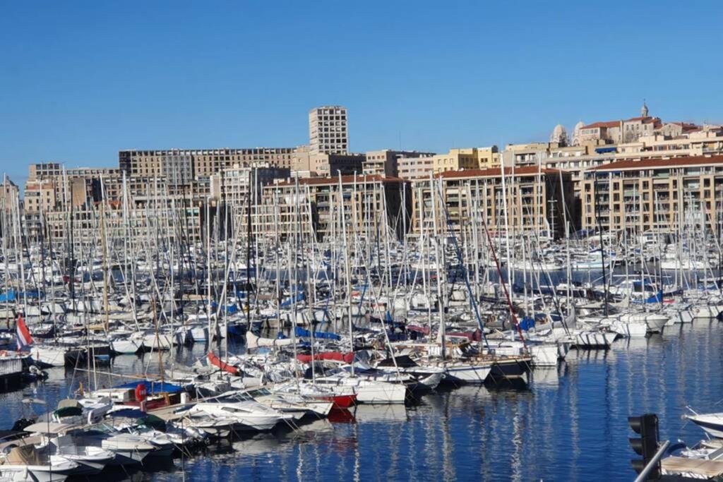 a bunch of boats docked in a harbor with buildings at Grand Loft en plein coeur du Vieux-Port in Marseille