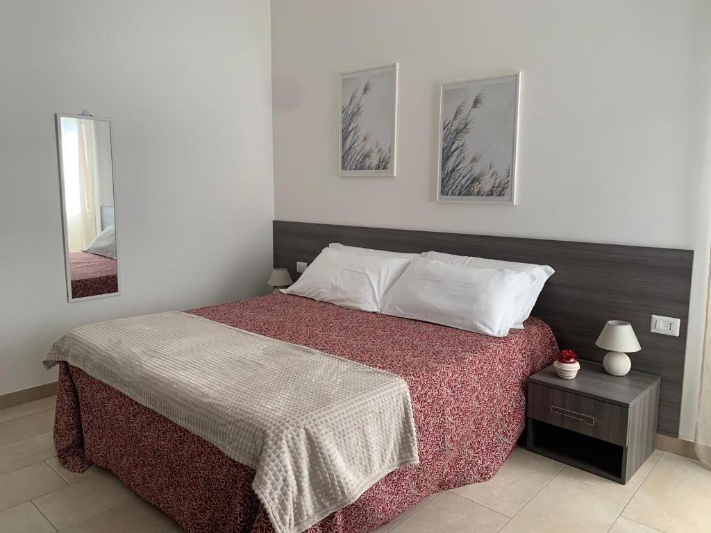 a bedroom with a bed and two pictures on the wall at B&B Al Ponte in Potenza