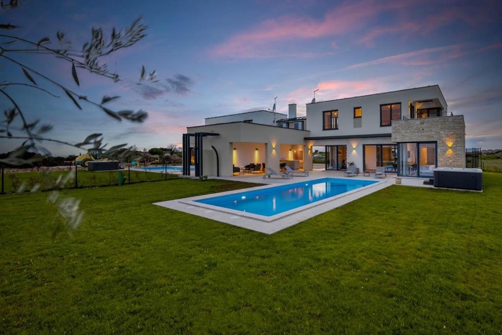 a house with a swimming pool in the yard at Villa Chiara by SeeAdria Agency in Brtonigla