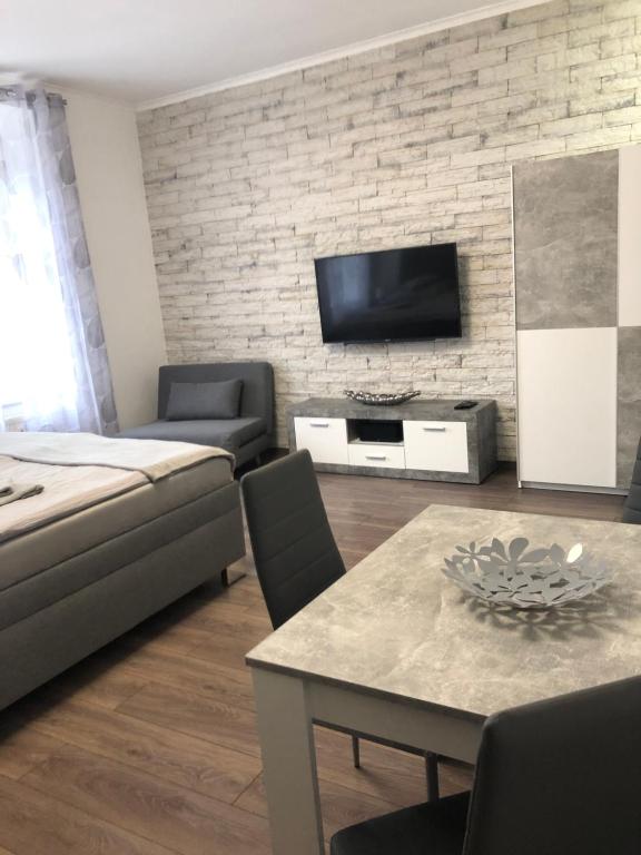 a living room with a couch and a table at Apartman Hanna in Karlovy Vary