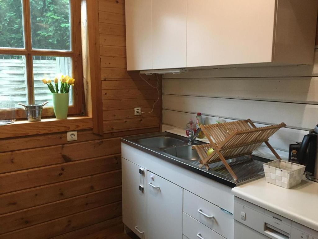 a kitchen with a sink and a counter top at Laras Ferienhaus in Worpswede