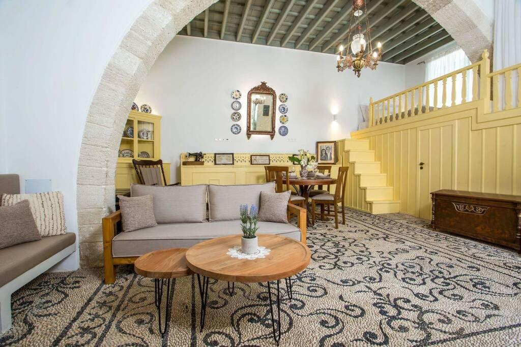 a living room with a couch and a table at Marouli Traditional House in Koskinou