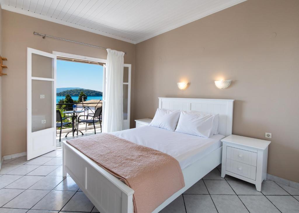 a bedroom with a bed and a view of the ocean at Spiros Sea View in Nydri
