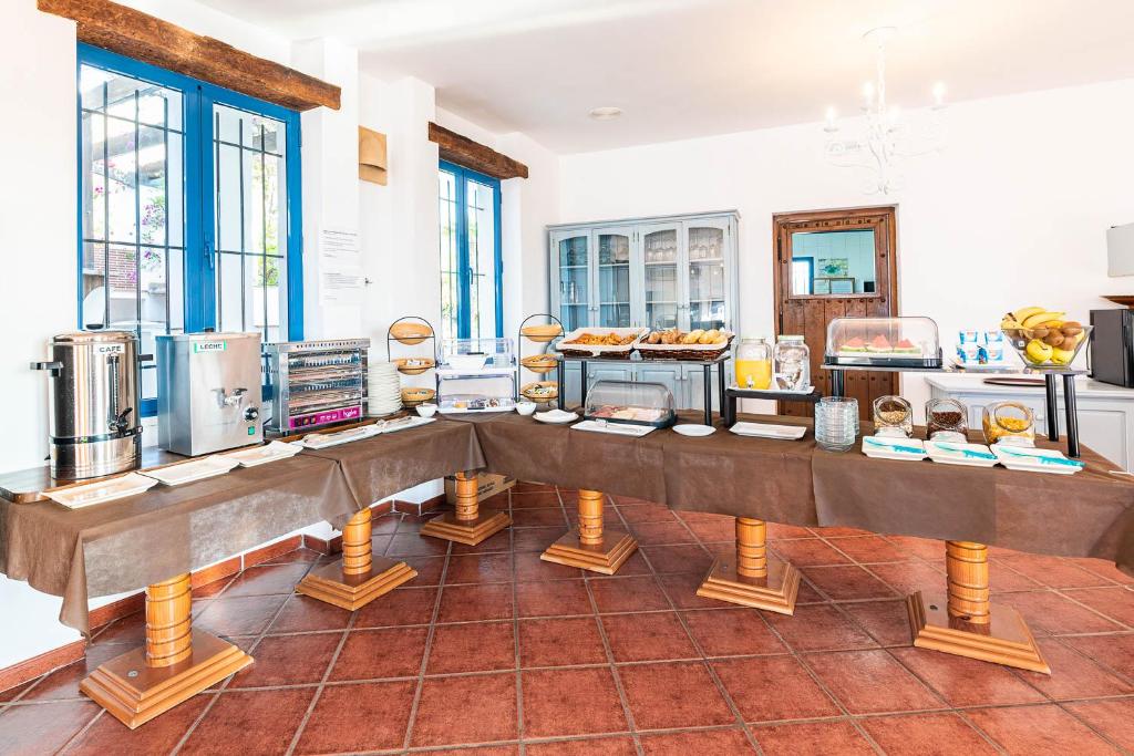 a kitchen with a table with food on it at Hostal El Dorado in San José