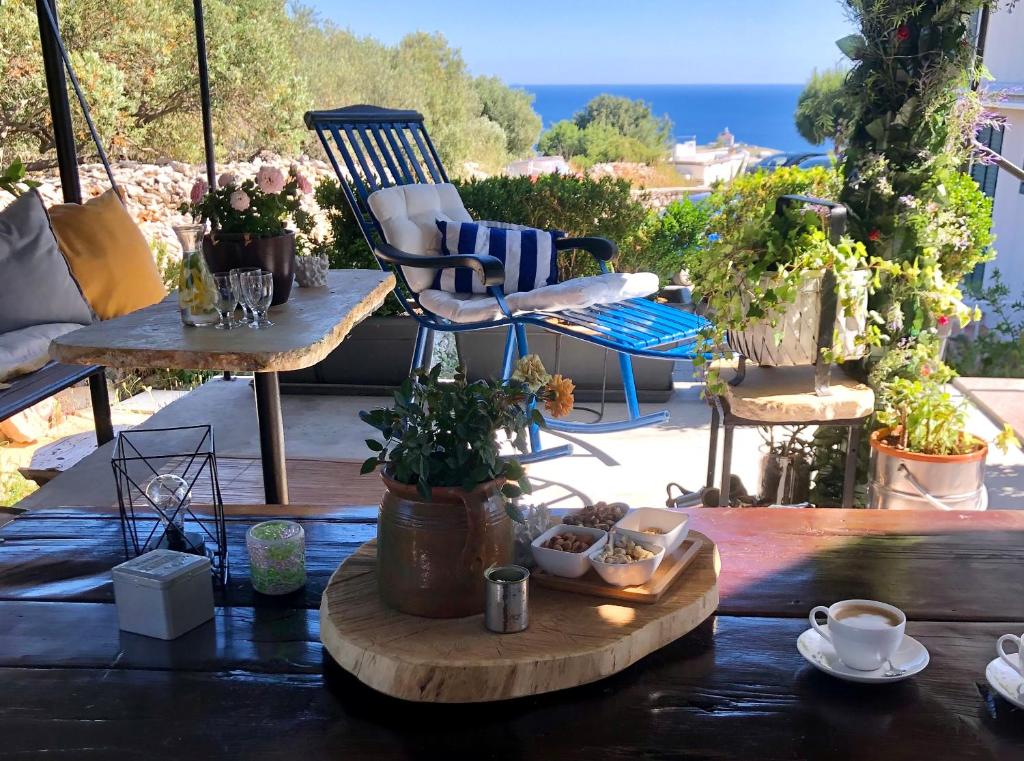 a patio with a chair and a table with plants at Apartments Coco in Hvar