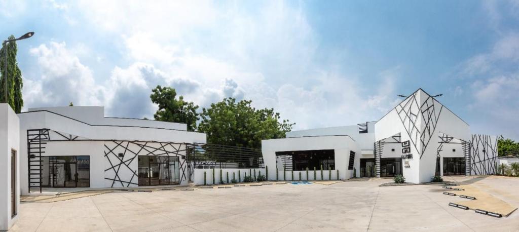 a large white building with a geometric design at D' LA TORRE HOTEL in Managua