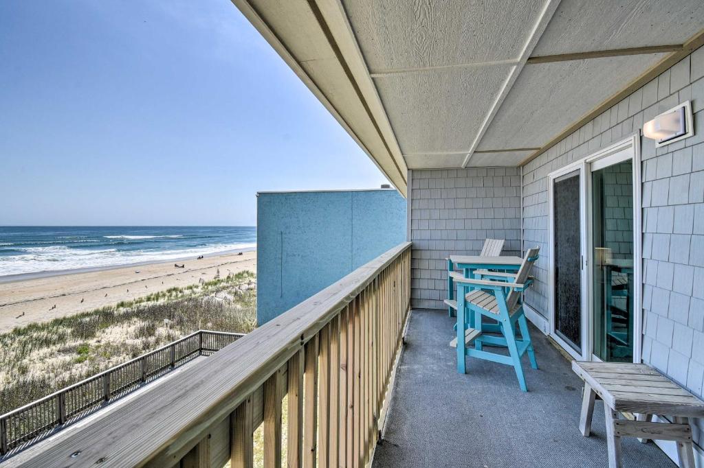 a porch with a table and a bench on the beach at Beachfront Nags Head Condo w/ Private Balcony! in Nags Head