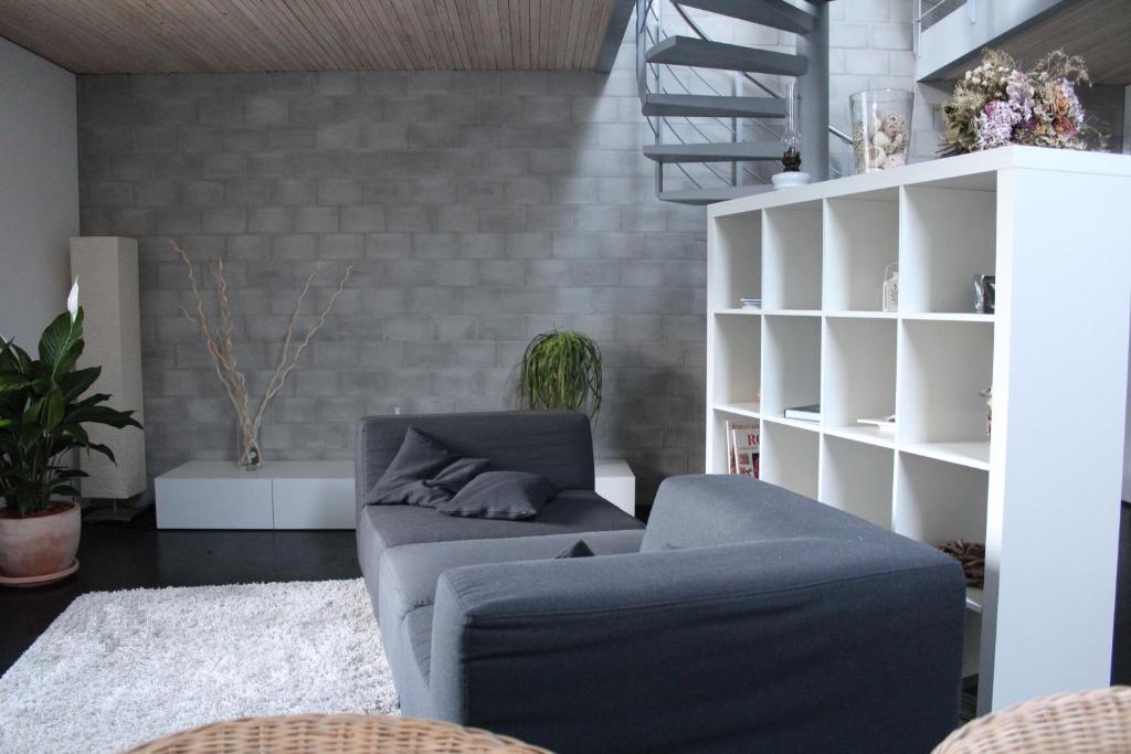 a living room with a couch and a chair at Carpe Diem - Bnb - Chambres d'hôtes in Péry