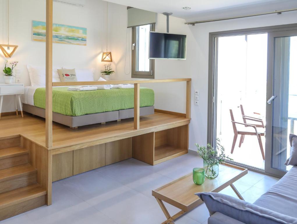a bedroom with a bed and a table and a couch at Georgia Villas in Skiathos
