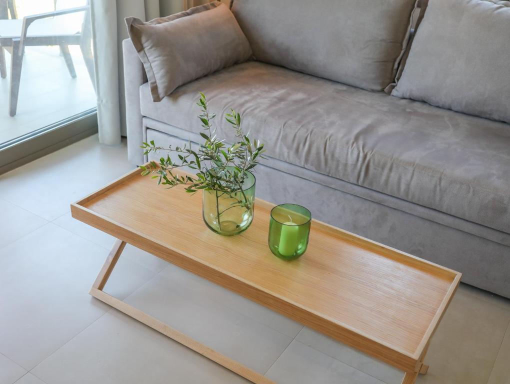 a coffee table with a vase and a candle on it at Georgia Villas in Skiathos