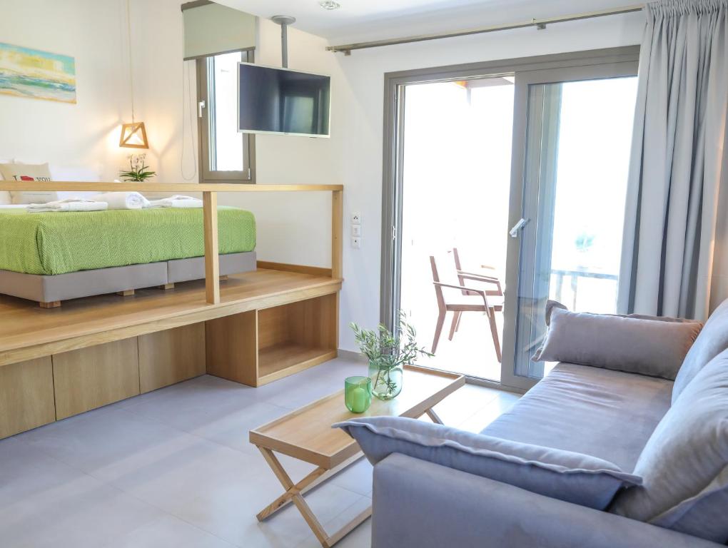 a living room with a bed and a couch at Georgia Villas in Skiathos
