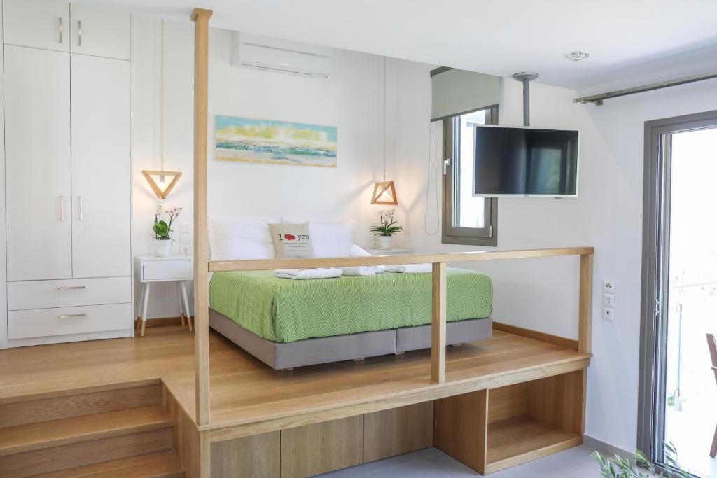 a bedroom with a bed with a tv on top at Georgia Villas in Skiathos