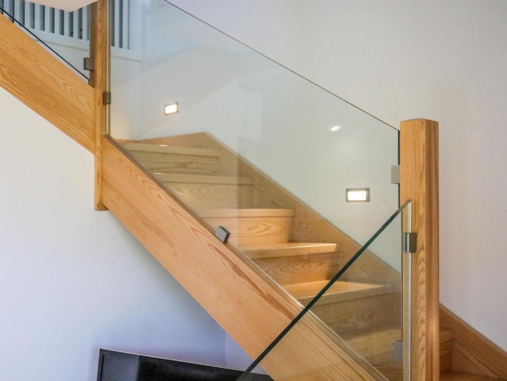 a staircase in a house with glass railing at Georgia Villas in Skiathos