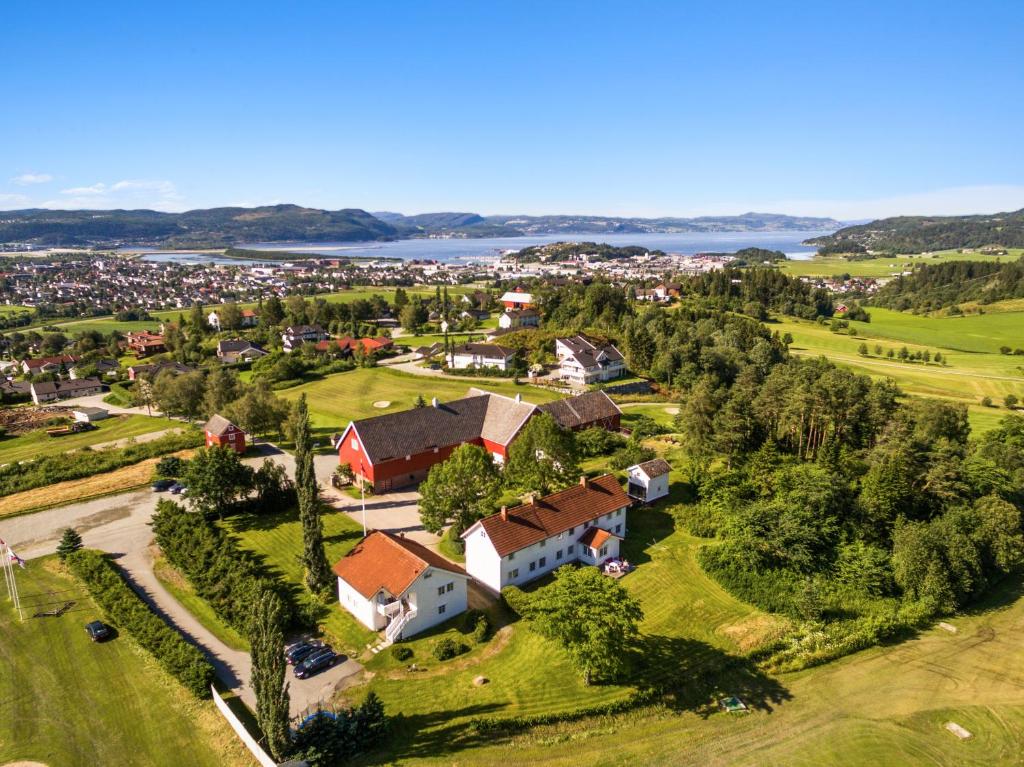 an aerial view of a village with a large house at Stokke Gård Adventure Bed & Breakfast in Stjoerdal