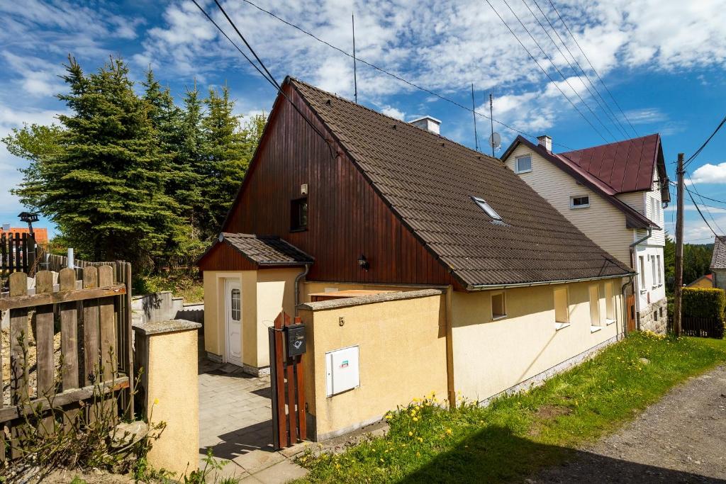 a house with a barn and a fence at Chata Nerudovka in Abertamy